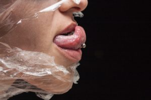 person with white plastic pack on mouth
