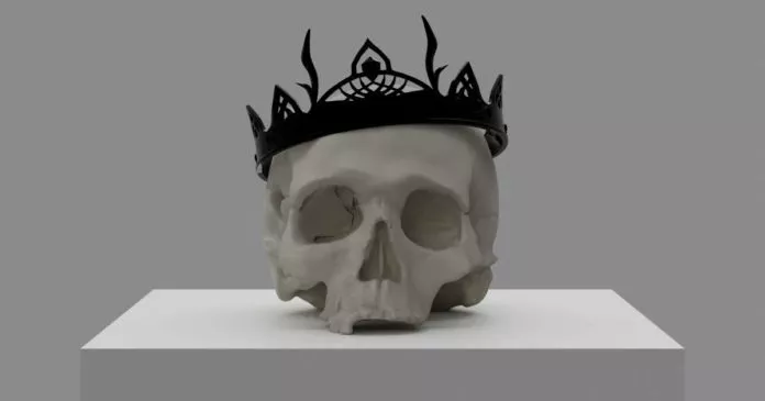 Ein weißer Totenschädel, der eine schwarze Krone trägt.