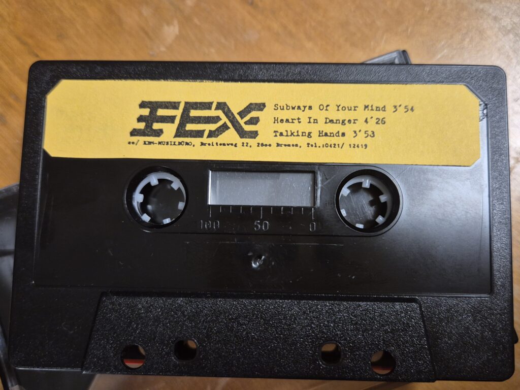 A tape with a yellow sticker from the band fex